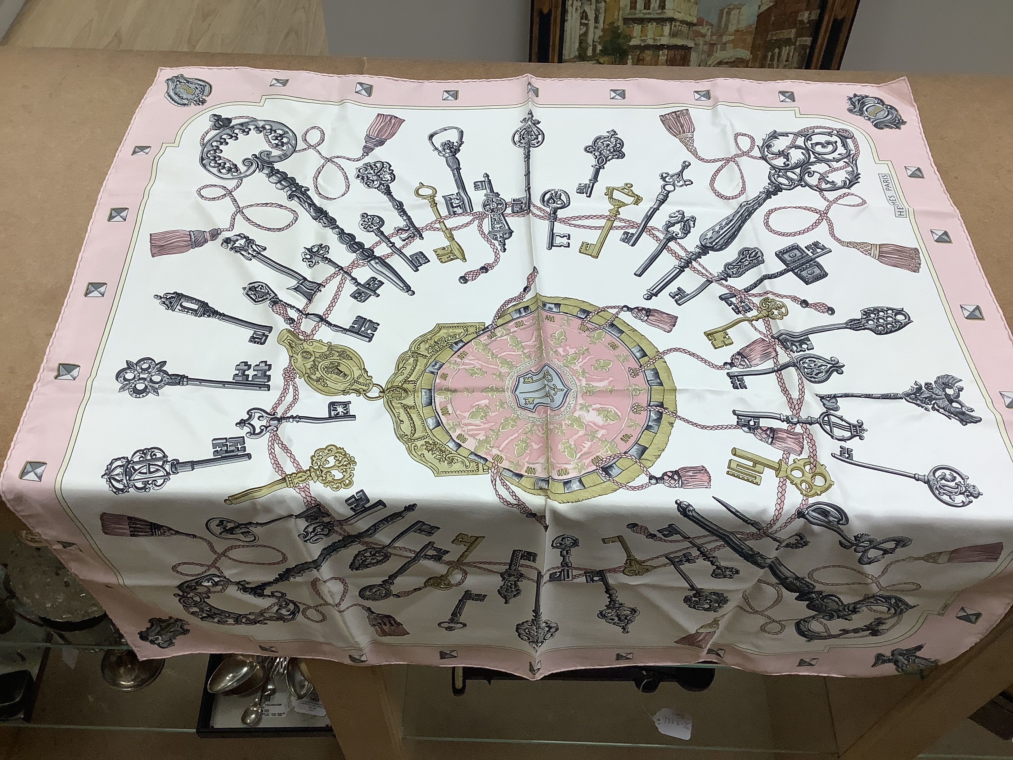 A Hermes, Paris silk scarf “Les Cles Bordeaux” with pink border and three Christian Dior silk scarves